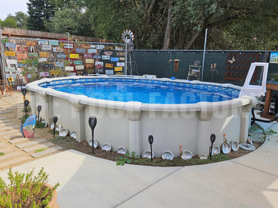 Oval semi-ground pool with decorative stone pathway and concrete patio