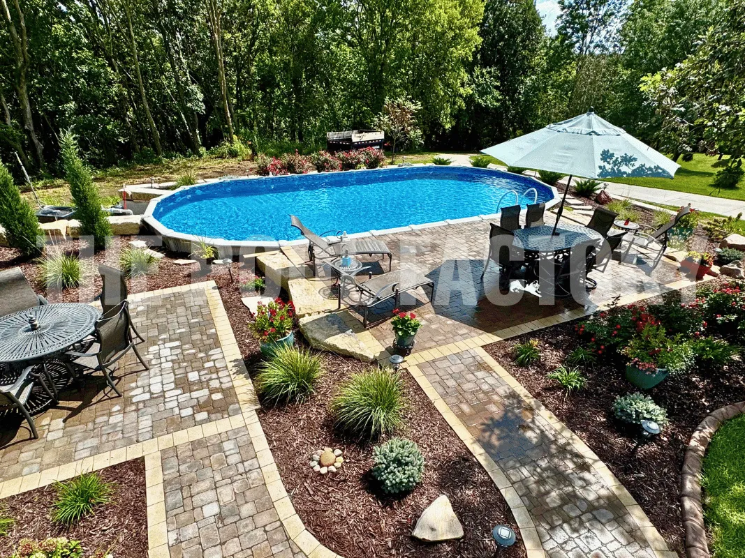 Backyard with oval semi-inground pool, outdoor seating area, sun loungers, and stone pathway