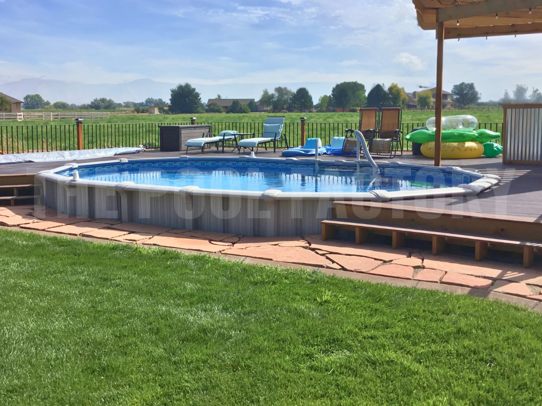 Oval-semi inground pool with partial deck and stone pathway