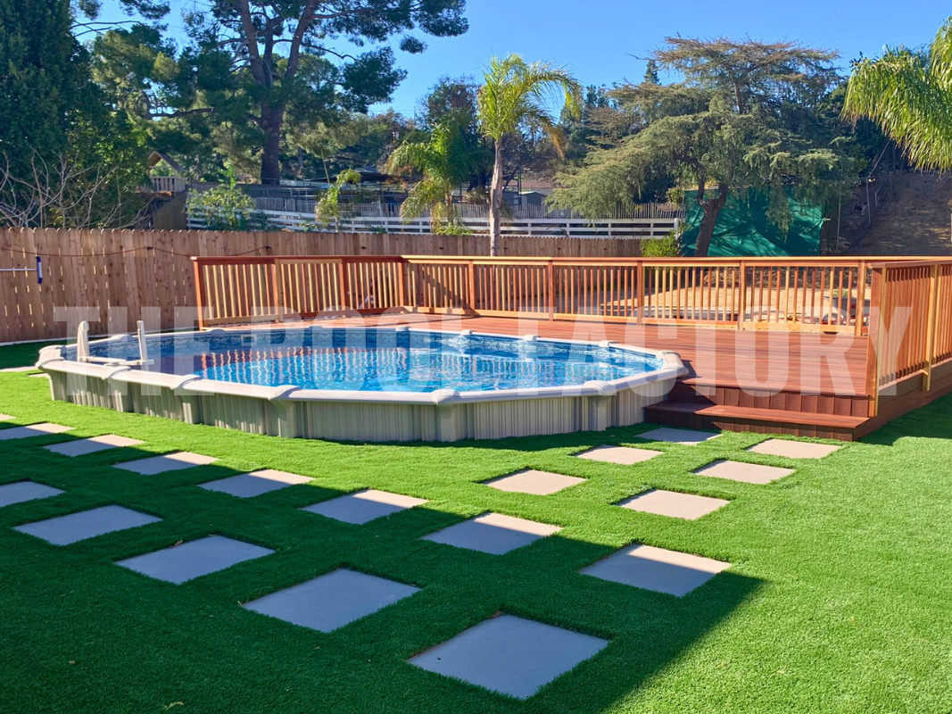 Oval semi-inground pool with deck and decorative stone pathway