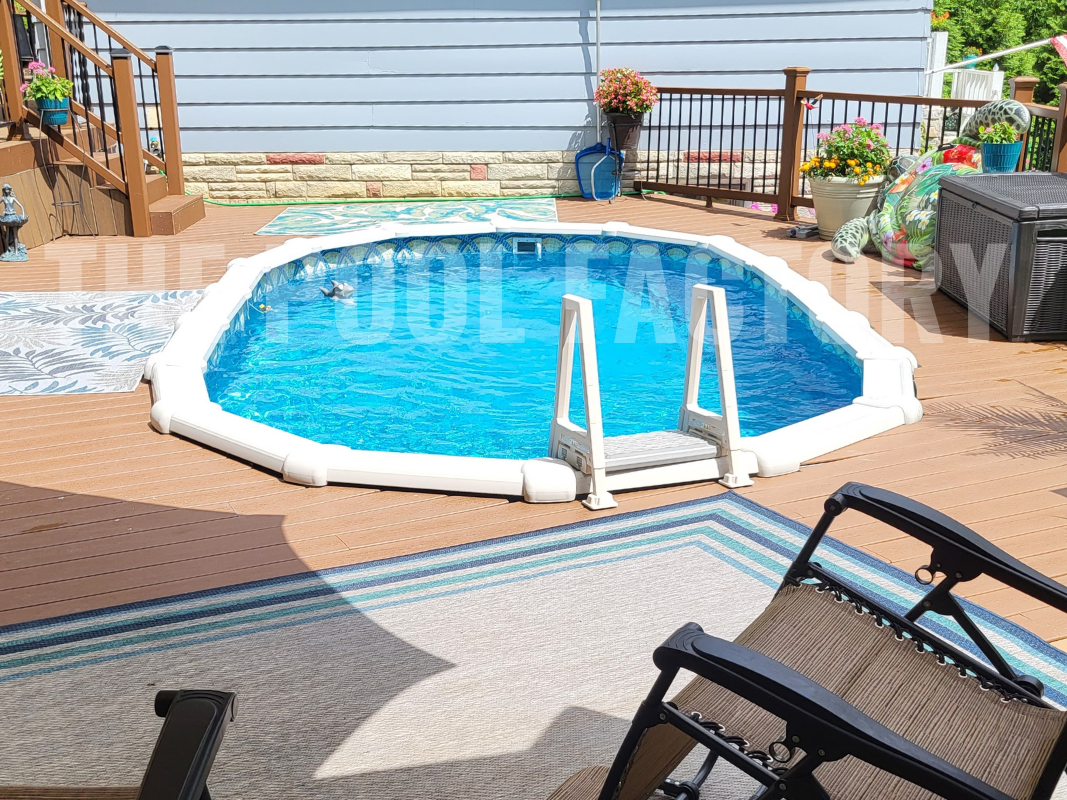 Oval above-ground swimming pool surrounded by a large deck