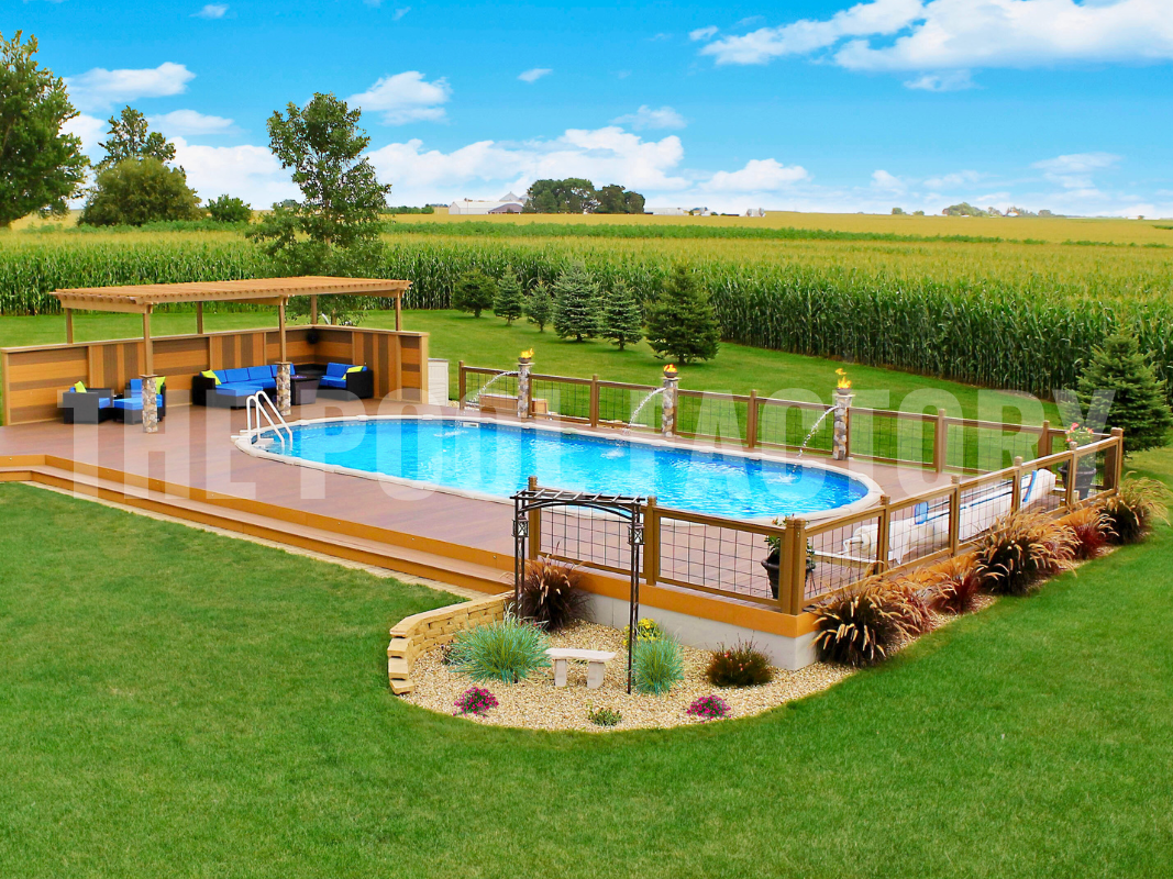 Oval semi-inground pool with a multi-level wooden deck and lush landscaping surrounding yard