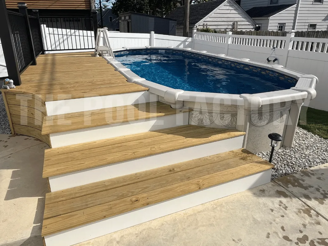 Oval above ground pool with partial deck and cement walkway