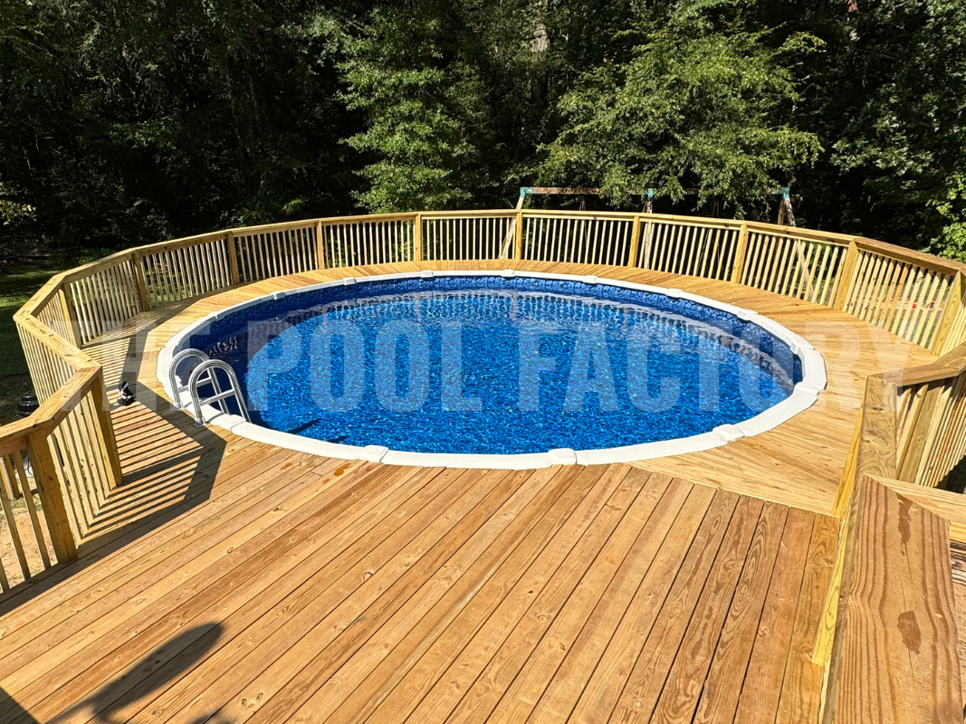 Round saltwater swimming pool with wrap around deck and forest view
