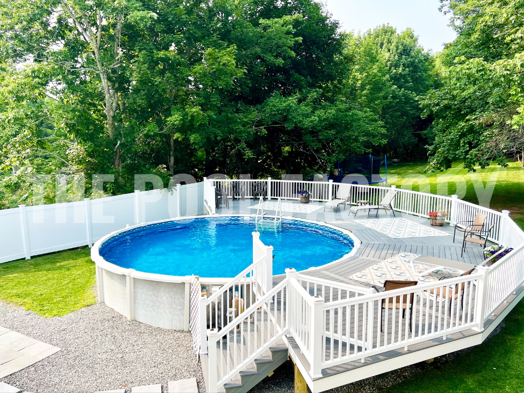 Saltwater above ground round pool with fan deck and lounge chairs