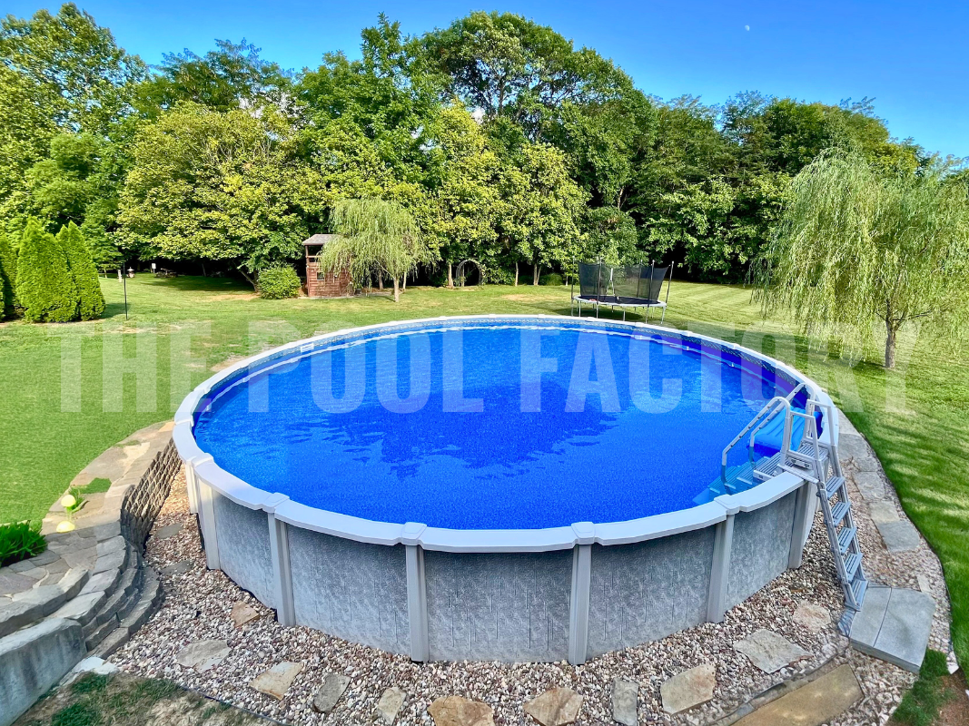 Backyard round saltwater pool surrounded by tall trees and concrete stepping stones
