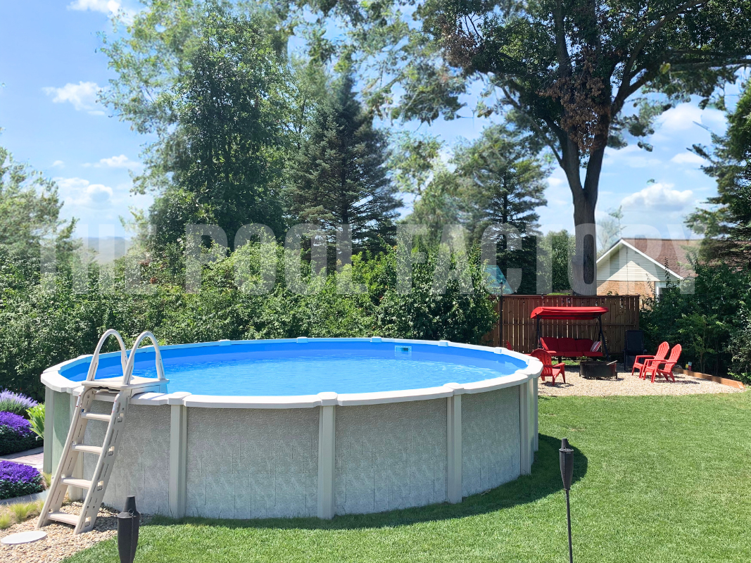 Above ground round saltwater swimming pool with large shrubs surrounding and fire pit with comfy seating