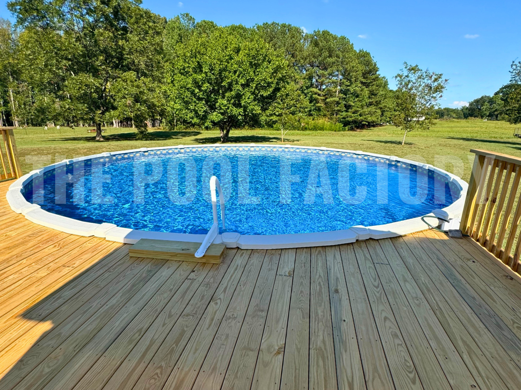Above-ground round saltwater pool with sunny garden, greenery, and partial deck 