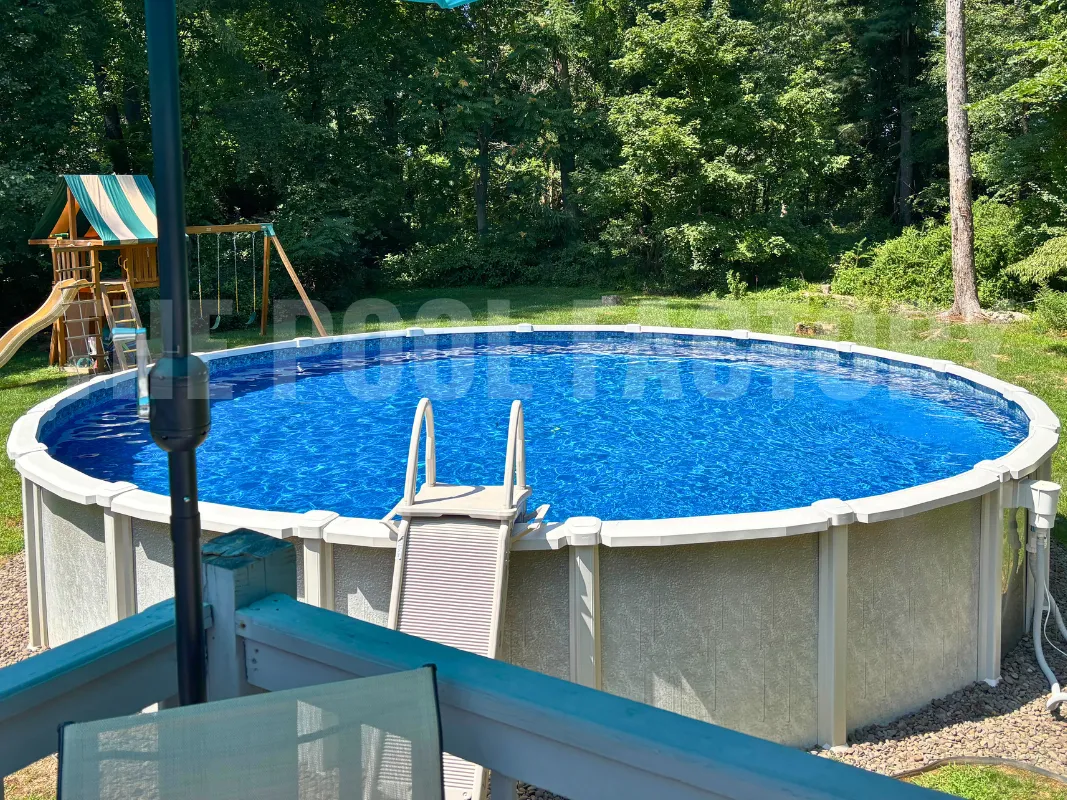 Round backyard saltwater swimming pool with A-Frame Safety Ladder and outdoor playset