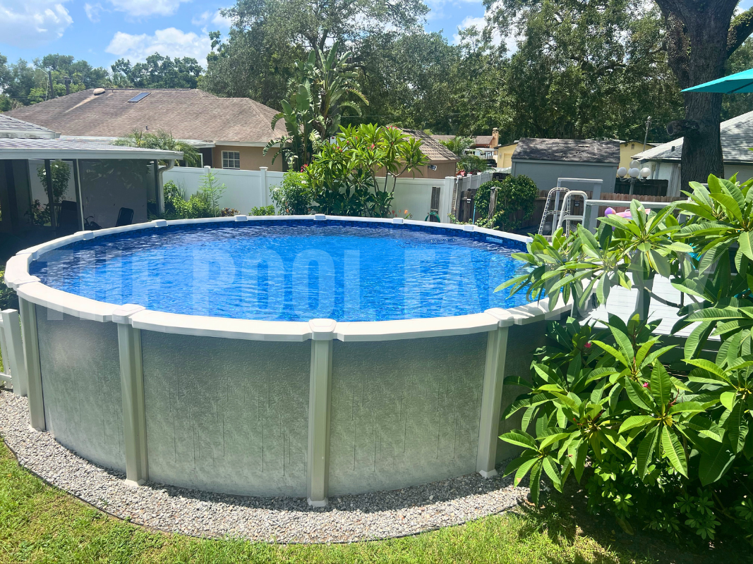 Round above ground saltwater swimming pool with decorative rock landscaping