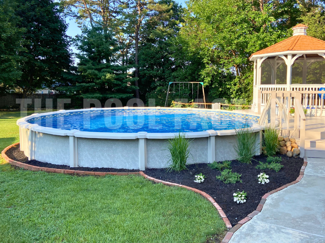 Semi inground round saltwater pool with side deck and gazebo