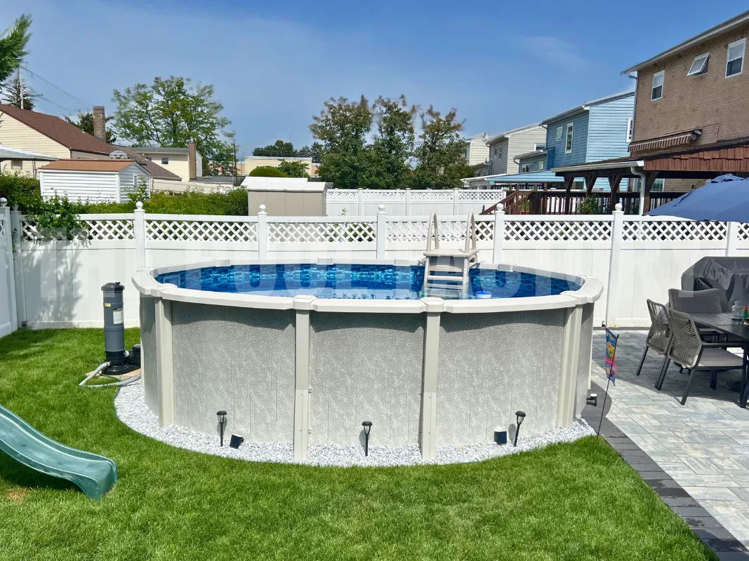 Saltwater above ground pool with modern concrete patio and surrounding fence