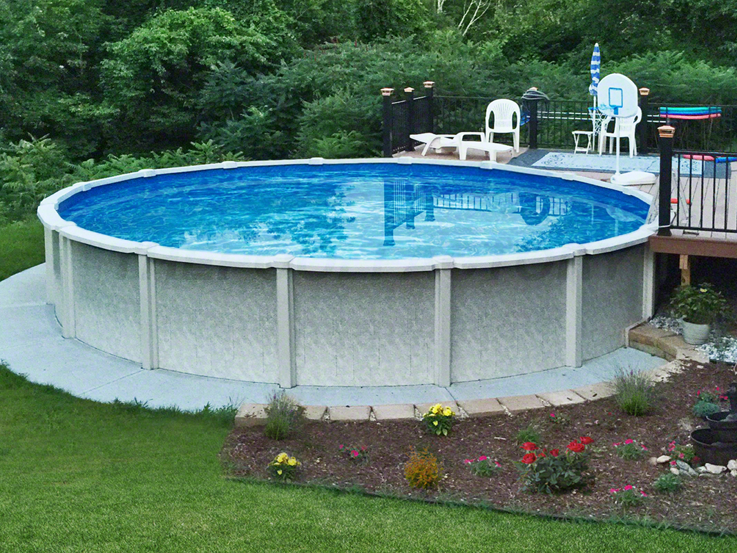 Saltwater round swimming pool pool above ground with surrounding concrete walkway and partial deck