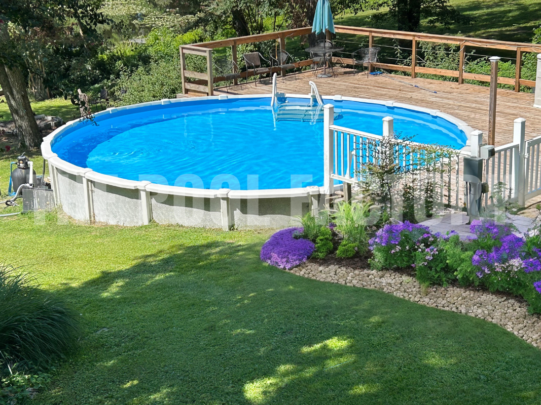 Round semi inground saltwater pool with partial deck on a hill