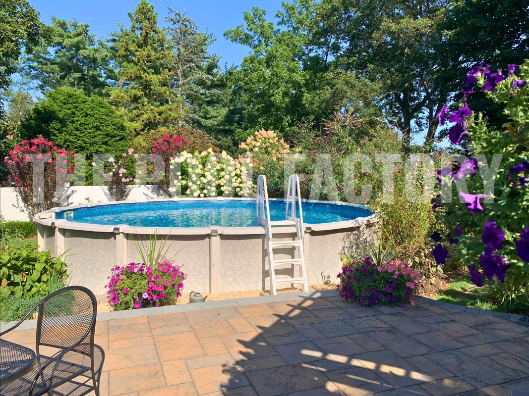 Round saltwater pool with vibrant landscaped garden and paver patio