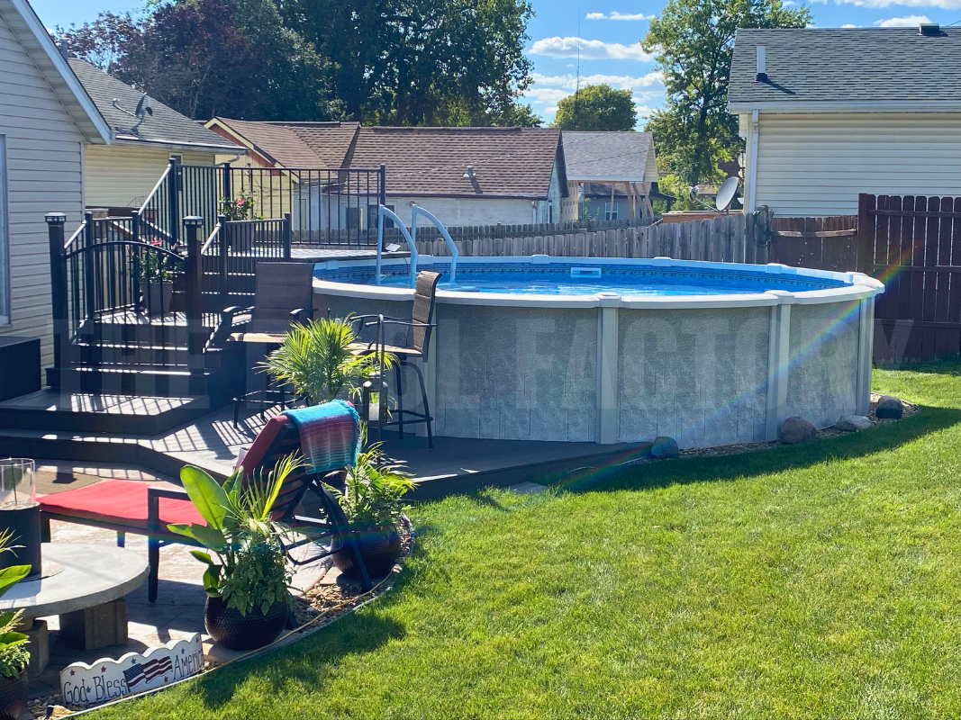 Above-ground saltwater round pool with side deck and well-maintained lawn