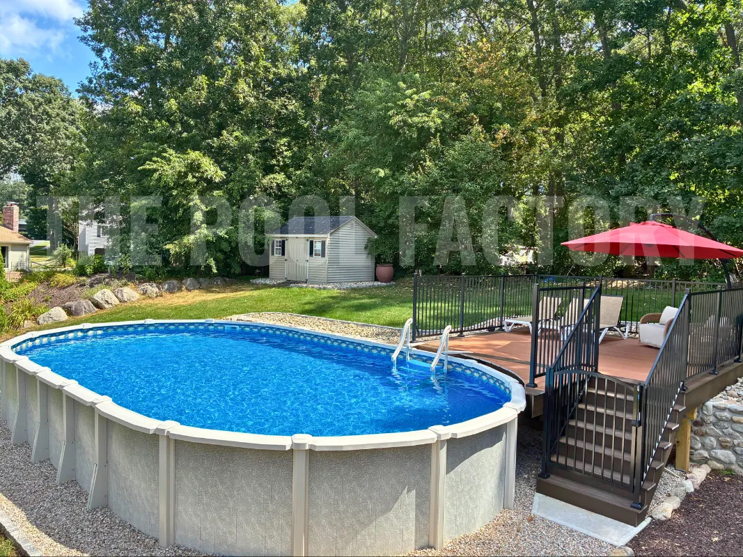 Oval above ground saltwater pool with Trex deck and umbrella for shading