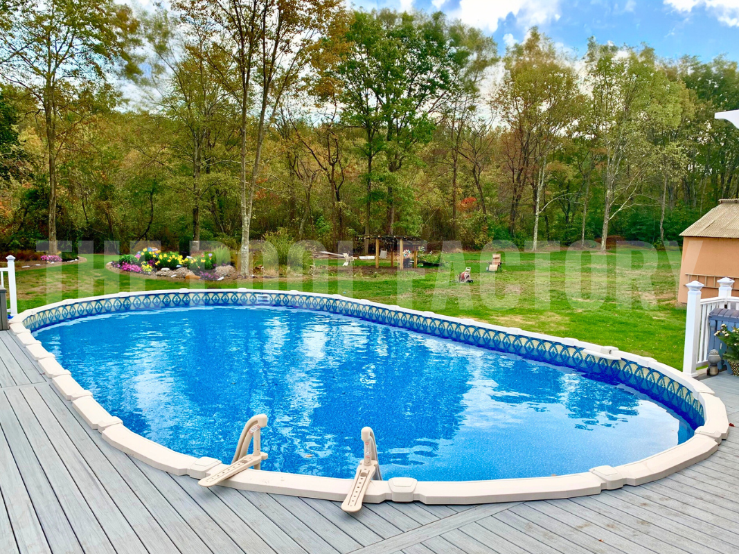 Oval above ground saltwater pool with partial deck and flower bed