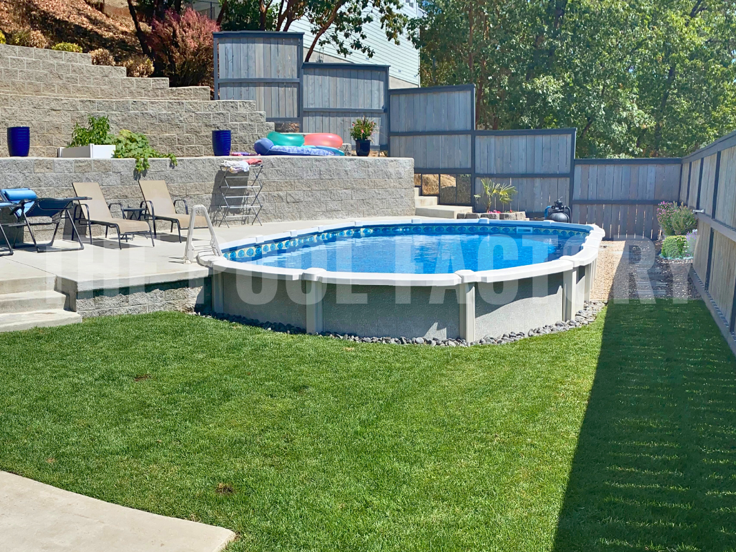 Saltwater oval pool with stone patio, plants, and decorative rocks