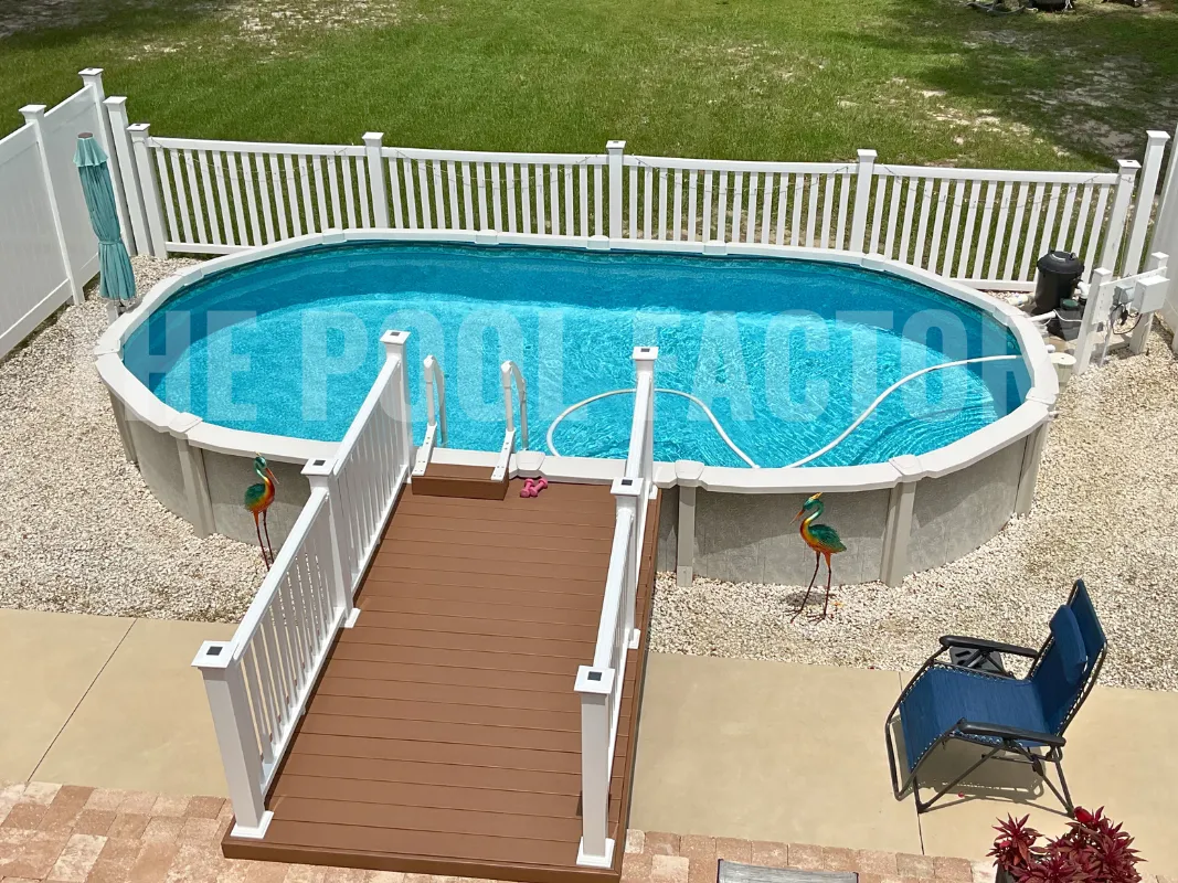 Oval above ground pool with deck platform for easy entrance and surrounding safety fence