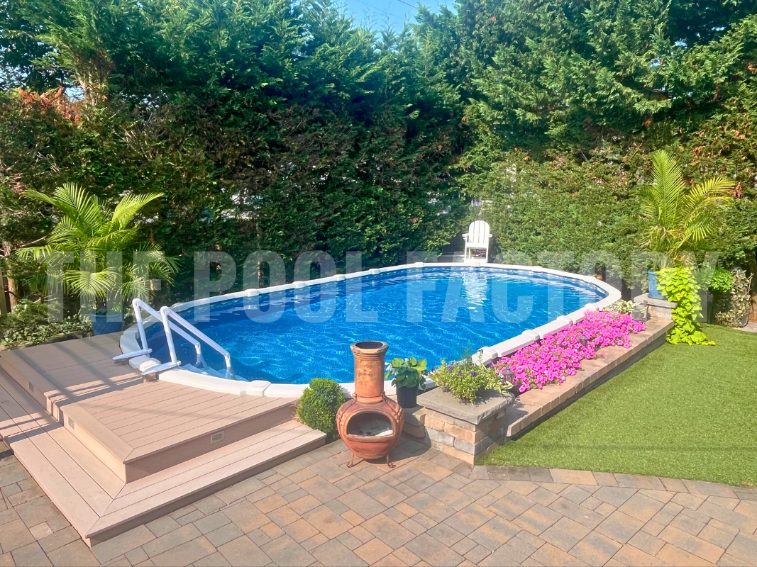 Semi-inground oval pool with platform deck, surrounded by shrubs and trees