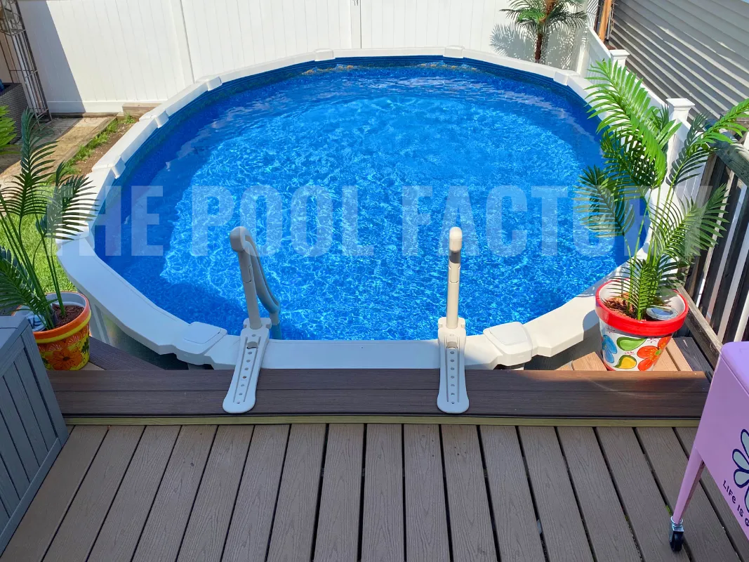 Modern backyard with oval saltwater pool and partial deck for outdoor relaxation