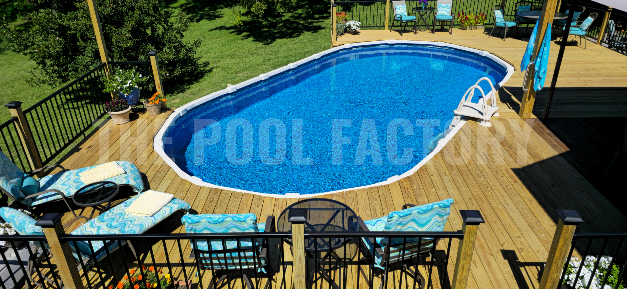 Oval saltwater pool with full deck, trees, and sunny day