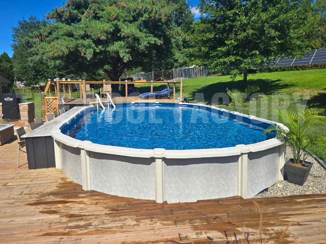 Relaxing backyard oasis with oval saltwater pool with deck patio and green grass