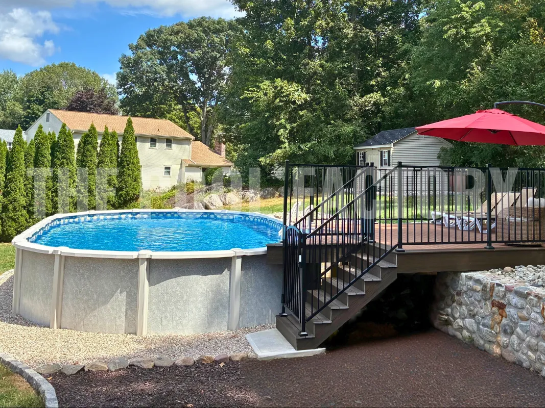 Backyard retreat with oval saltwater pool, deck, and decorative fence