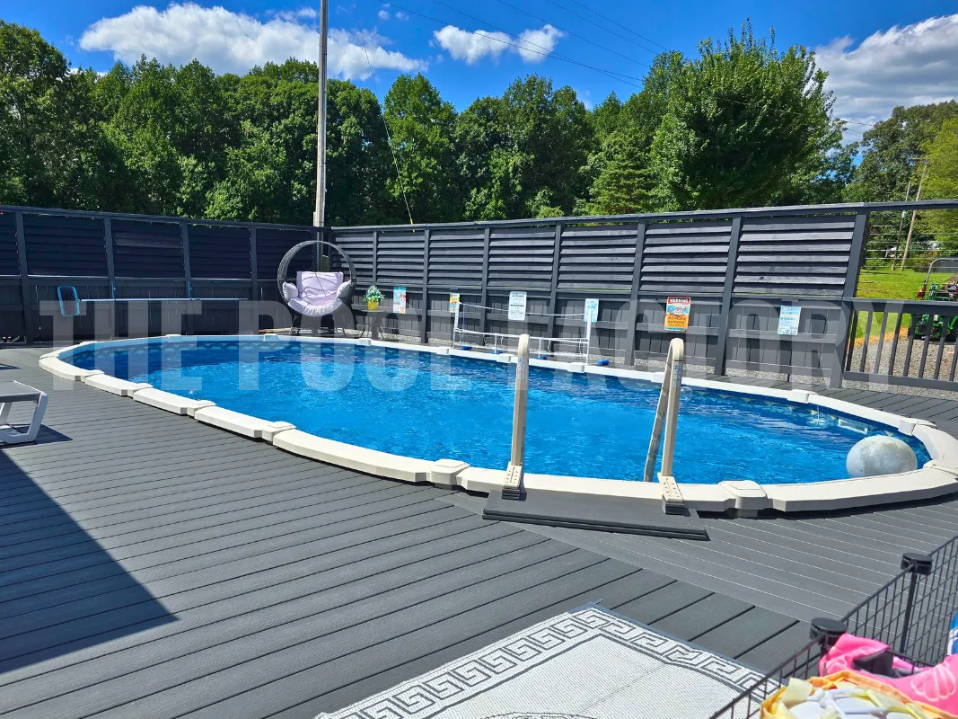 Oval saltwater swimming pool with fan deck and patio furniture