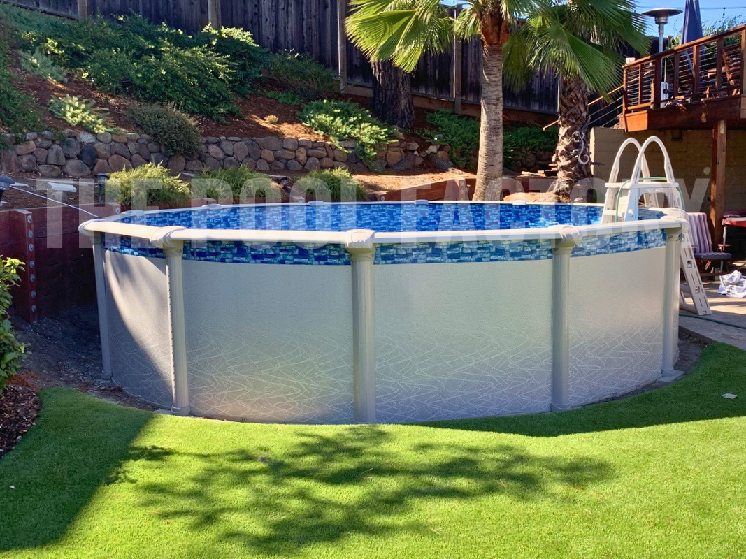 Round above-ground saltwater swimming pool in a backyard with green turf and palm tree in background