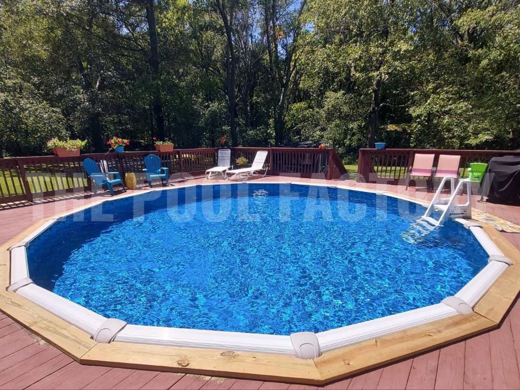 Semi-inground round saltwater pool with forest view, wrap around deck, and sunny garden