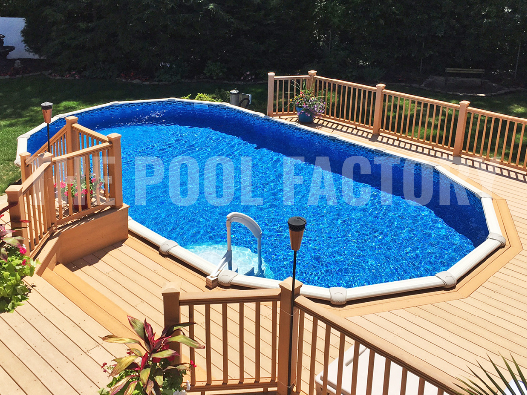 Oval saltwater above ground swimming pool with multi level deck on a sunny day