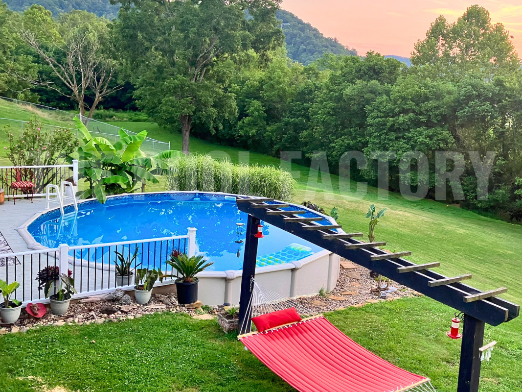 Round semi inground saltwater pool with partial deck, hammock on a hill view setting