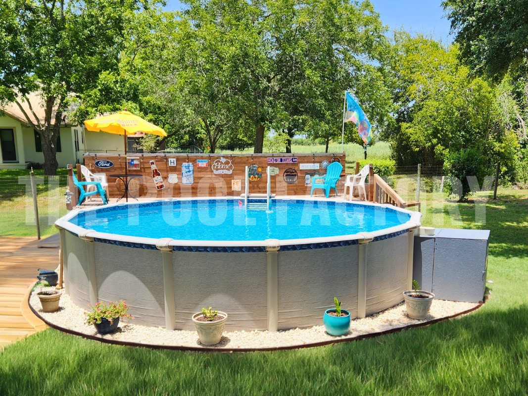 Above ground swimming pool with partial deck and seating on a sunny day