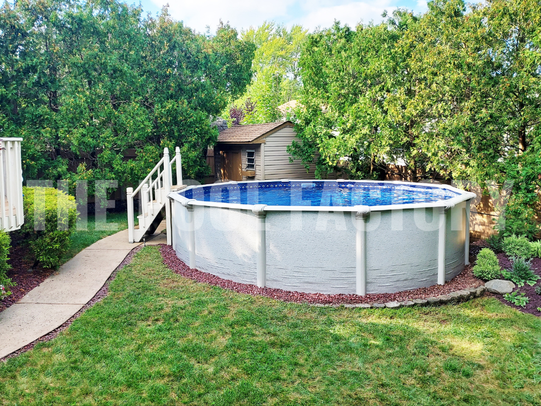 Round above ground pool surrounded by green hedges