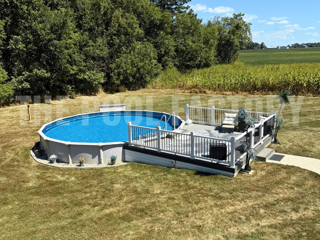 Round above ground swimming pool with wooden deck, lounge chairs, and landscaped yard