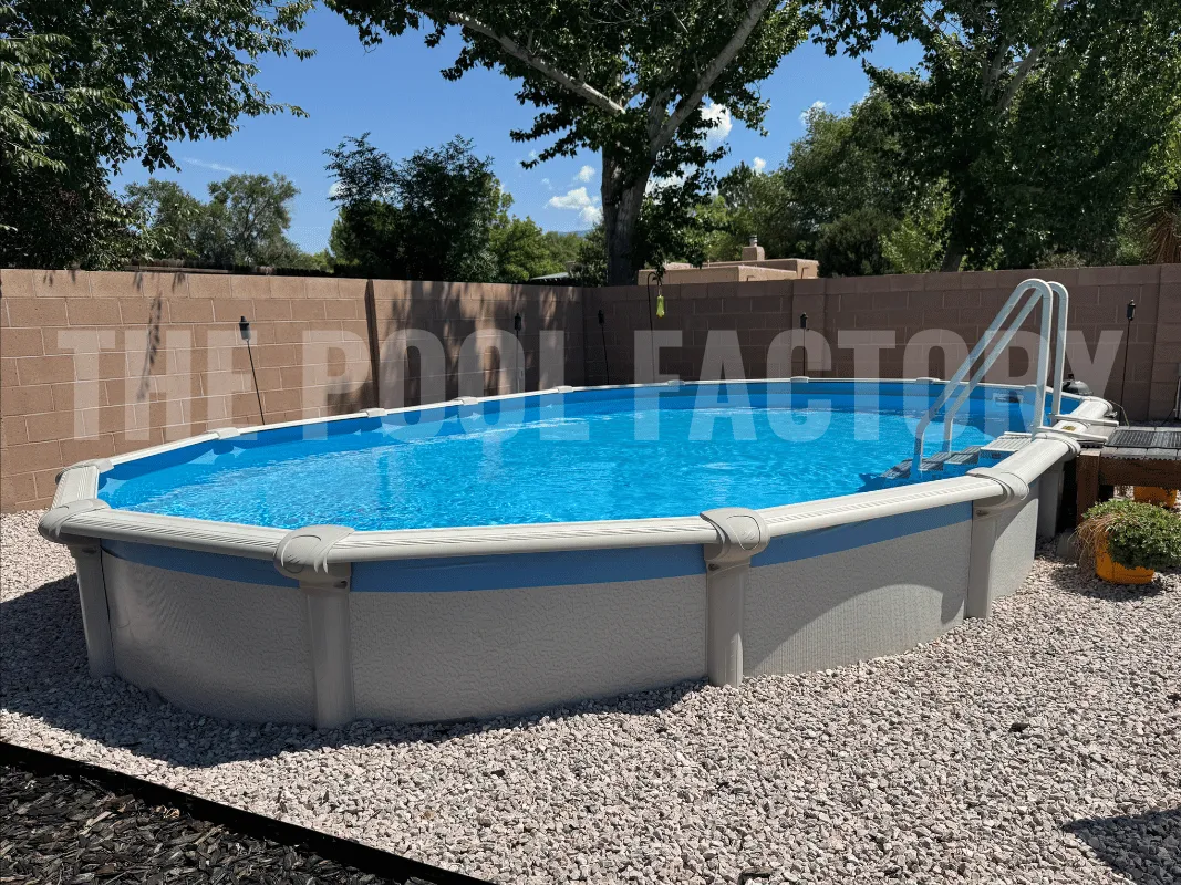 Large oval swimming pool with in-pool step and decorative rock border