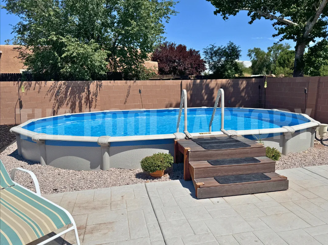 Semi-inground pool featuring an in-pool step and surrounded by brown privacy fence