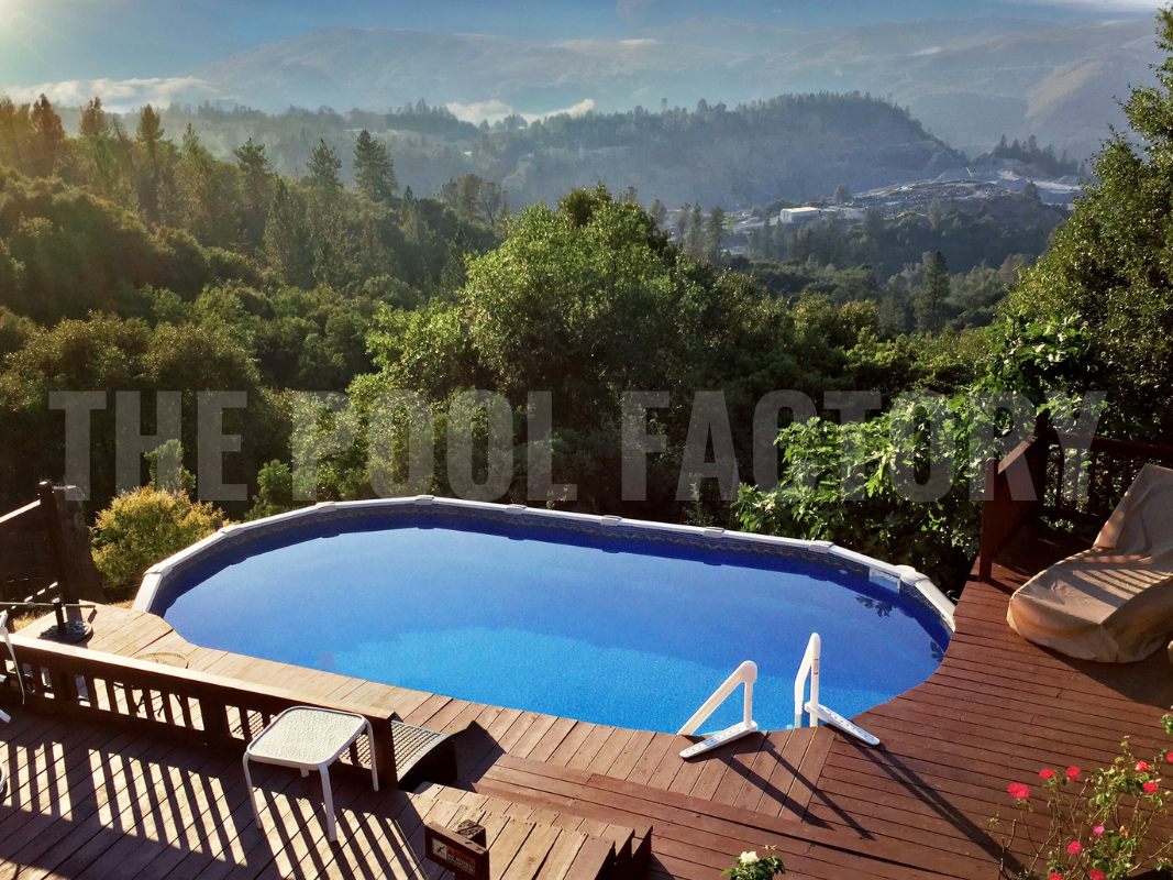 Oval above ground swimming pool with deck, mountain view and greenery 