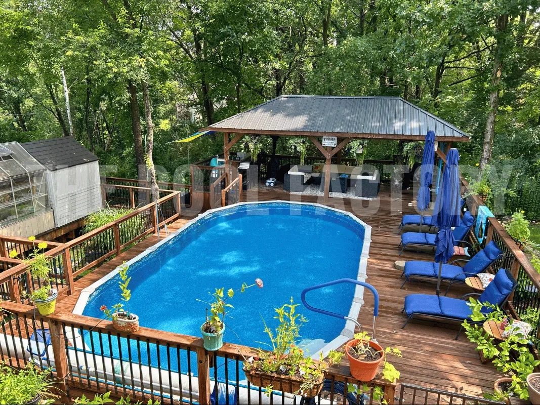 Family oval swimming pool with built-in deck, outdoor lounge chairs, and decorative flowers