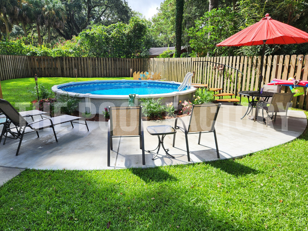 Above ground saltwater round pool with concrete patio, surrounded by lounge chairs and trees