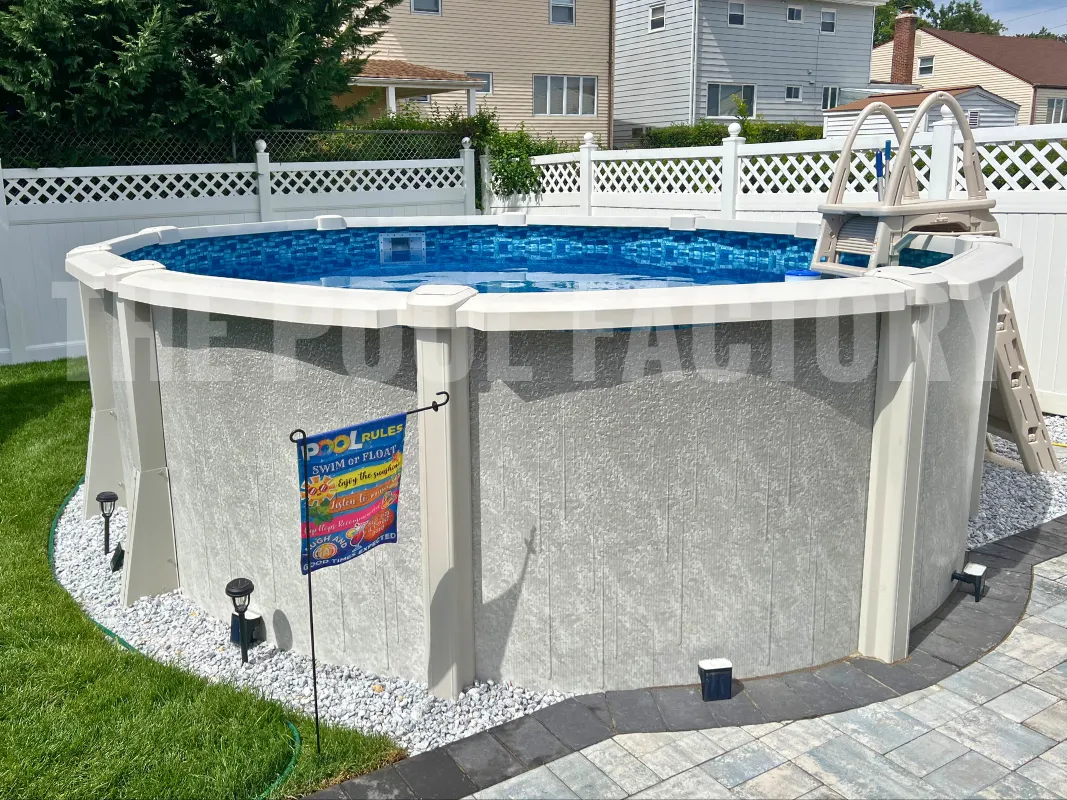 Saltwater round pool with decorative paver patio, grass yard, and enclosed fence