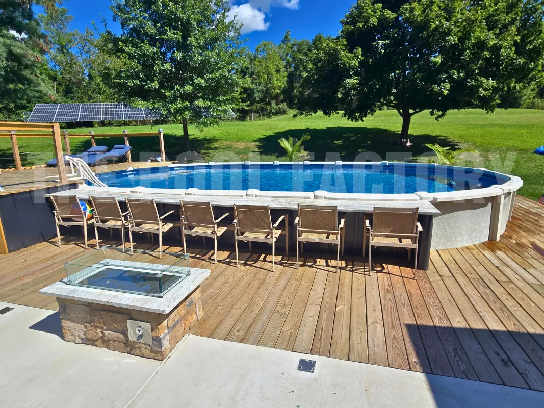 Oval above ground saltwater pool with chairs around the deck and green garden backdrop