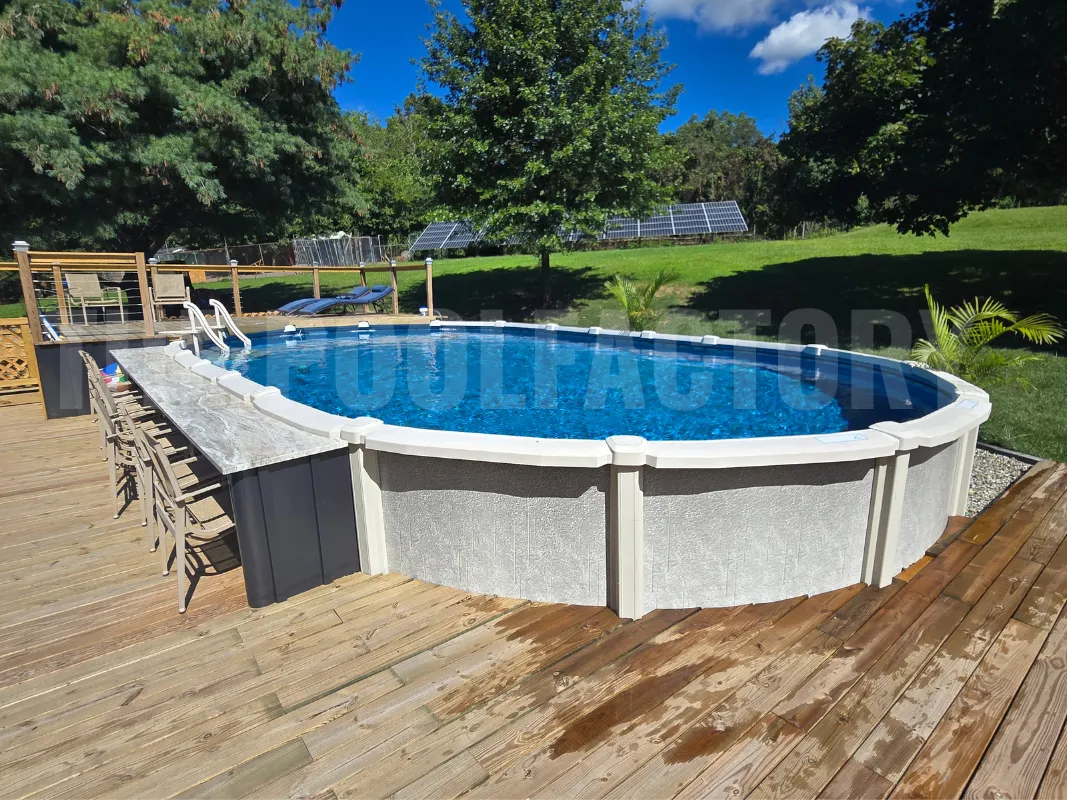 Saltwater oval pool with chairs placed around a stone countertop flush to the pool and partial deck