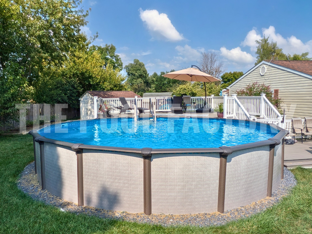 Round above ground swimming pool with deck and decorative stones
