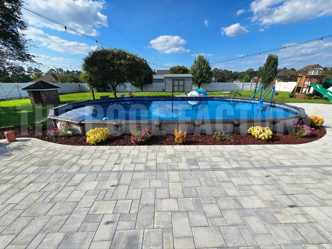Semi-inground oval swimming pool with lush plants