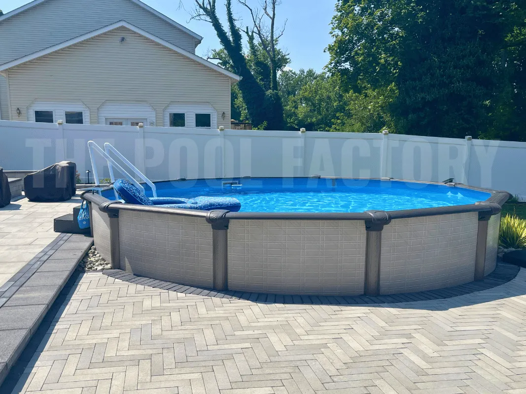 Above ground round swimming pool with stone paver patio
