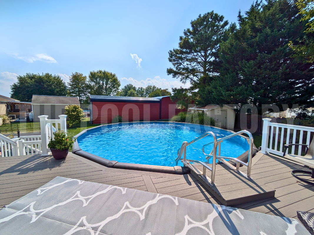 Above ground round swimming pool with deck and lounge chairs