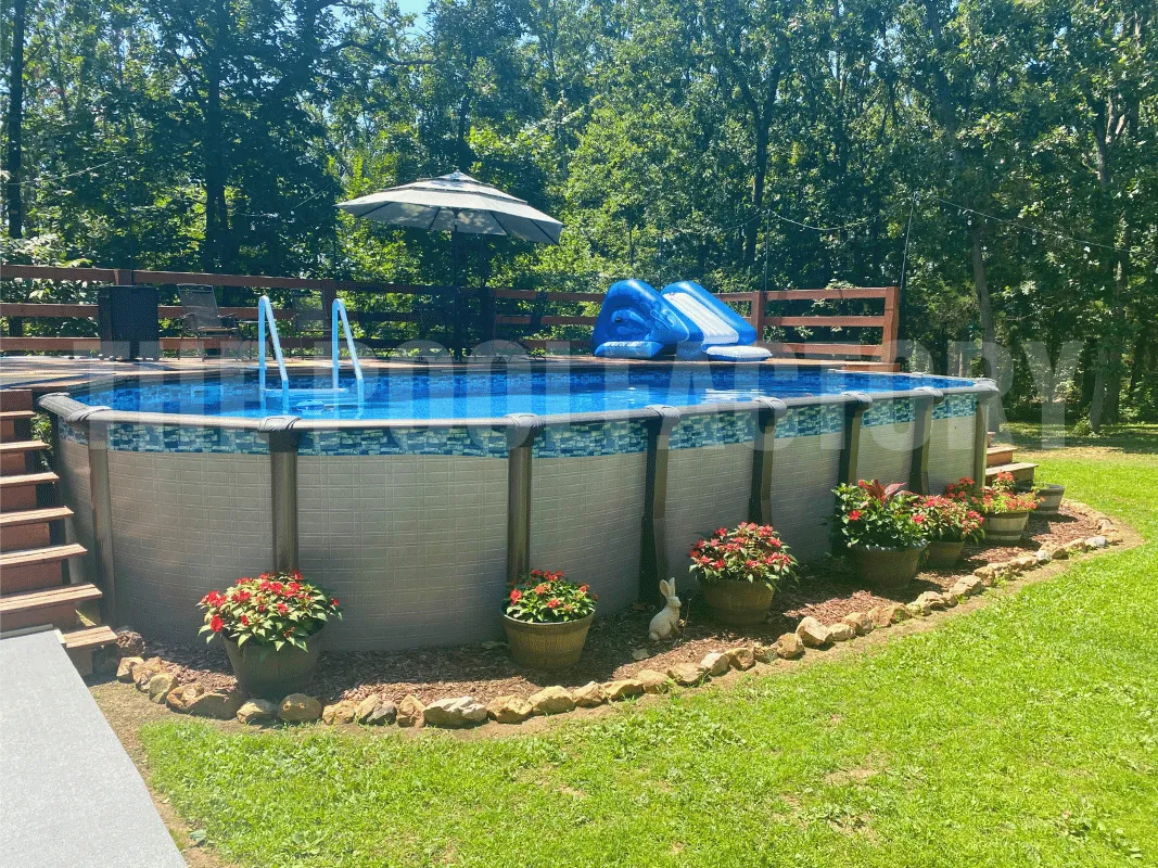 Cozy backyard with oval pool, partial deck, and colorful garden flowers